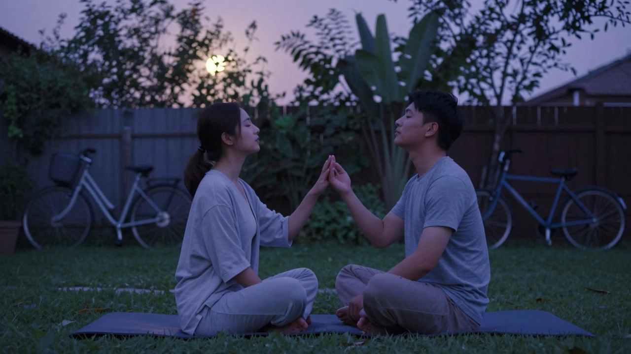 Couple practicing mindful breathing together in a quiet garden at dusk.